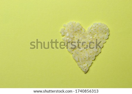 White rice in the shape of a heart, abstract beautiful background