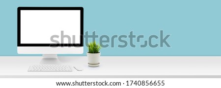 Mockup desktop computer display blank screen on desk in office, workspace with mock up computer screen empty, plant and copy space on table in home, business presentation concept, banner website. Royalty-Free Stock Photo #1740856655