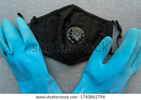 Blue gloves and black facemark ready to be worn during the coronavirus pandemic 