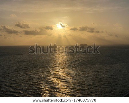 Sun set on the ocean with cruise ship