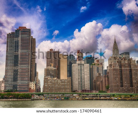 Manhattan skyline as seen from East River on a sunny day.