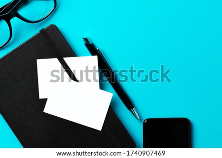 White businesscard with copy space on black notepad