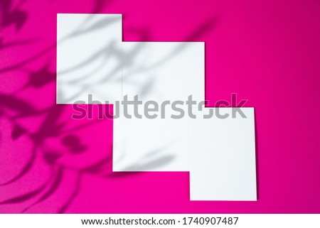 Advertising mock-up. White blank businesscards on bright pink background