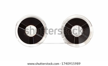 Vintage open reel audio tapes moving from one reel to another. Isolated on white.