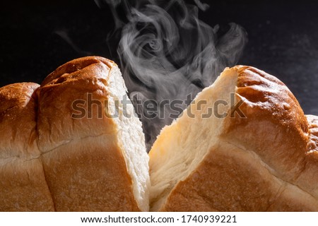 Steam rising from the baked bread.