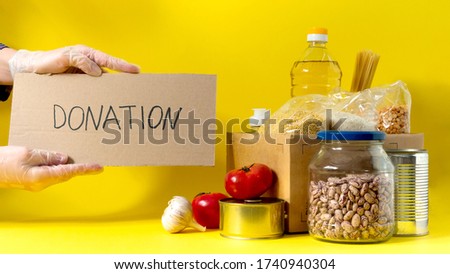 Banner.Donation. Food supplies crisis food stock for quarantine isolation period on yellow background. Rice, peas, cereals, canned food, oil, vegetables, mask, sanitizer. Food delivery. Cope space.