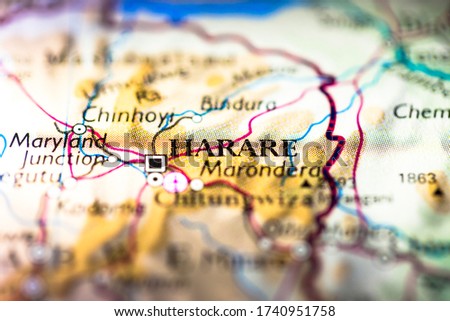 Shallow depth of field focus on geographical map location of Harare city in Mashonaland Zimbabwe Africa continent on atlas