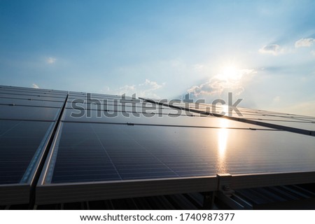 Solar panels and blue sky background.Solar cells farm on the roof.Photovoltaic modules for renewable energy.Save the earth and the energy with good environment concept.