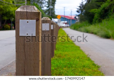 multiple wooden fencing post on walkway 