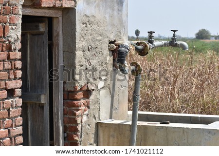 Old model well and man filling water in pump, picture taken at Sivakasi, Tamilnadu, India on 3/3/2020 Royalty-Free Stock Photo #1741021112
