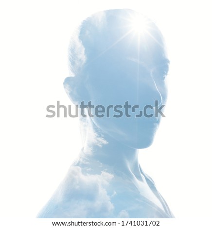  Mystical female person silhouette in double exposure with sun and cloudy sky