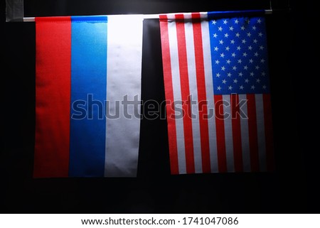 The concept of diplomatic relations. Flag of the United States of America and Russian Federation. Sanctions pressure in politics.