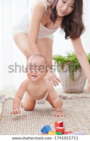 Happy mother and son play