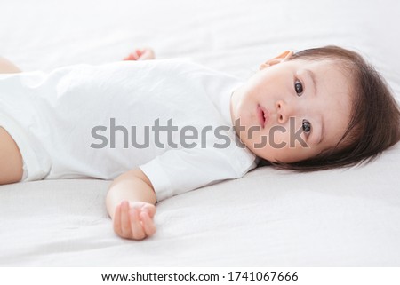 Lovely baby lying in bed