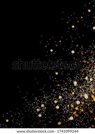 Black background with golden sparkles. Blurred  effect. Creative copy space for design.