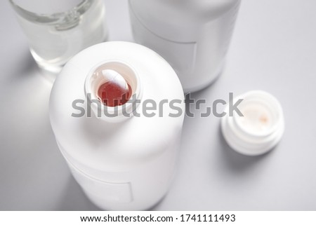Set of plastic shampoo, cosmetics bottles on grey background