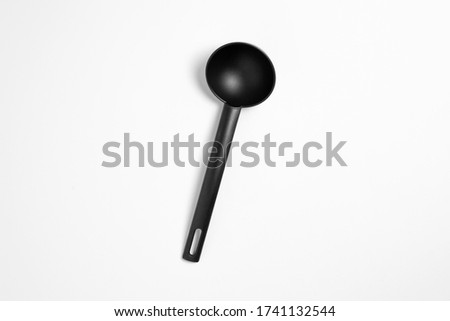 Black plastic soup ladle isolated on white background.The big black serving spoon.High resolution photo.