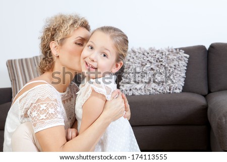 Mother kisses her daughter
