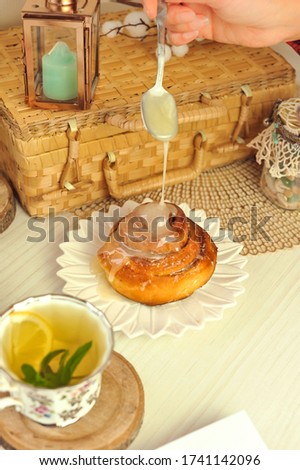 Fresh homemade muffin with a cup of green tea with lemon on the table with place for your text.
