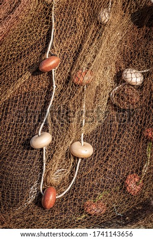 Closeup of a pile of fishing nets with a white rope and cork floats. Port of La Spezia, Liguria, Italy, Europe