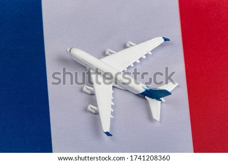 Flag of France and toy plane. Concept of air travel in France. Air travel in Europe after quarantine.