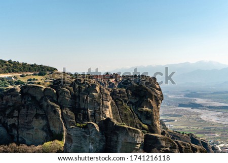 rock formations in mountains against blue sky in greece