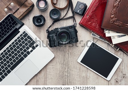 Hipster photography equipment with laptop and digital tablet on a vintage wooden desktop, flat lay