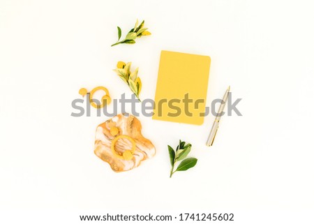 Resin art with yellow diary, pen and leaves on white background. Flat lay, top view