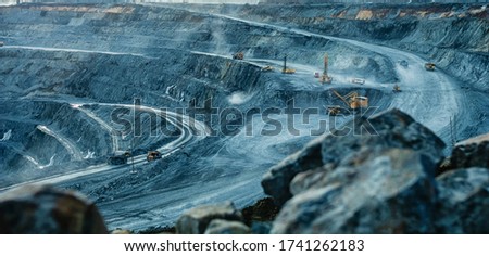 Work of trucks and the excavator in an open pit on gold mining, soft focus Royalty-Free Stock Photo #1741262183