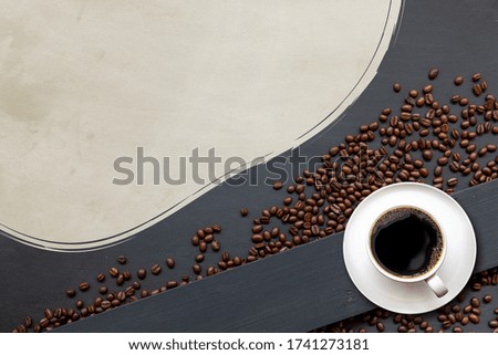 cup of coffee on black wooden floor background. top view. space for text