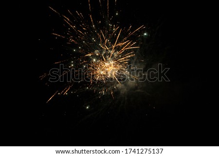 Holiday background with firework. Beautiful Single Golden firework isolated on black background.  