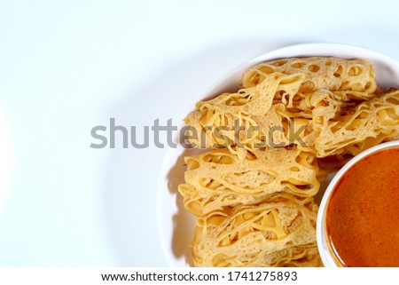 Roti Jala, literally meaning `Net Bread`, is a popular Malay tea time snack served with curry dishes which can be found in Indonesia, Malaysia and Singapore. 