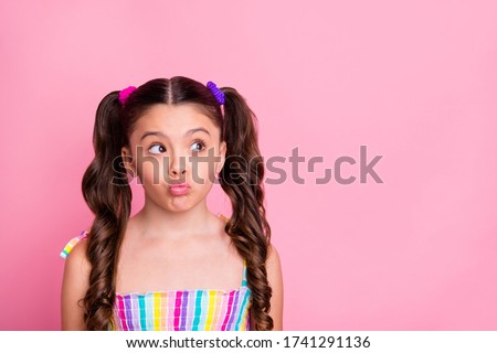 Photo of beautiful pretty funny little lady two cute curly tails look interested side empty space send air kisses shy girl wear colored dress summer singlet isolated pink color background