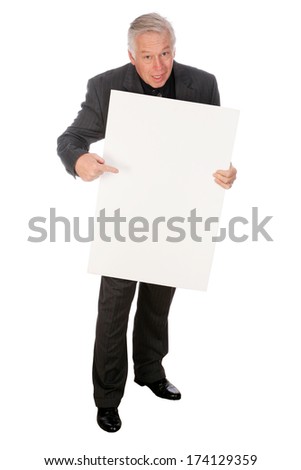 A Handsome Middle Aged Business Man points to and holds a white sign with room for your text or image. The perfect Sign Holding image for all your advertising needs. Images and text easily replaceable