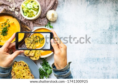 Phone photography of vegan food. Make picture of hummus and tortillas. Copy space Royalty-Free Stock Photo #1741300925