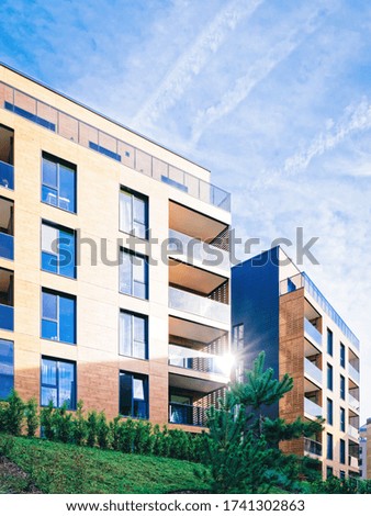 Modern residential apartment and flat building exterior. Part of New luxury house and home complex. City Real estate property and condo architecture. Copy space. Blue sky