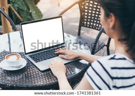 computer mockup image blank screen with white background for advertising,hand woman work using laptop contact business search information on desk at coffee shop.marketing and creative design
