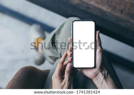 cell phone Mockup image blank white screen.woman hand holding texting using mobile on desk at coffee shop.background empty space for advertise.work people contact marketing business,technology 