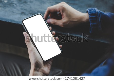 cell phone Mockup image blank white screen.woman hand holding texting using mobile on desk at coffee shop.background empty space for advertise.work people contact marketing business,technology