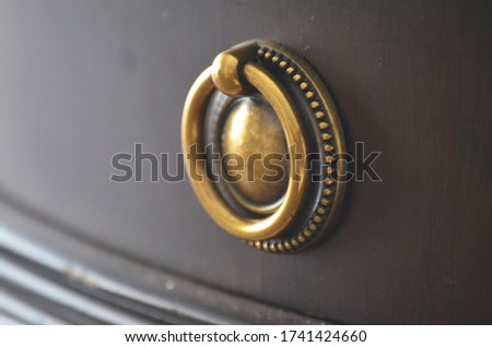 copper knocker of wooden drawer