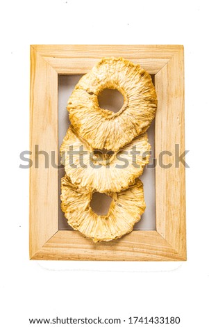 pineapple rings dried fruits in a frame for a photo isolate on a white background
