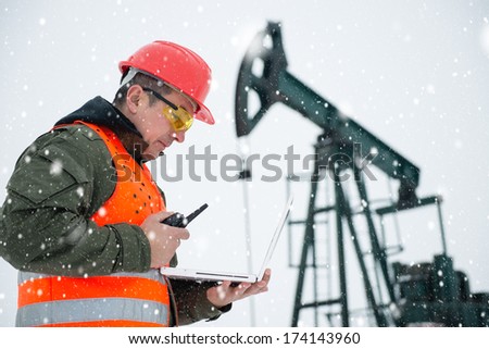 Oil Drill, field pump jack with snow storm and worker. See more images and video from this series and Refinery series. 