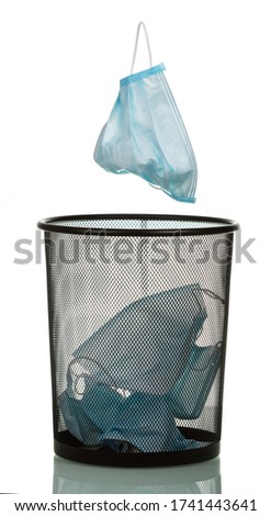 Another medical mask flies into the bin, isolated on white background Royalty-Free Stock Photo #1741443641