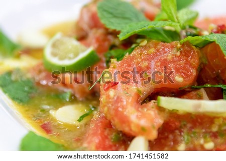 Spicy salmon salad with herbs; delicious fusion food. 