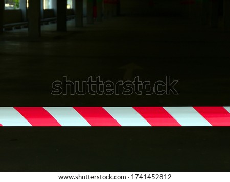 Barrier tape Red and white wire Prevent the lack of input Red and white obstacles on a dark background, realistic red and white danger tape