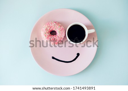 Happy morning! Donut and coffee on a plate. Funny face