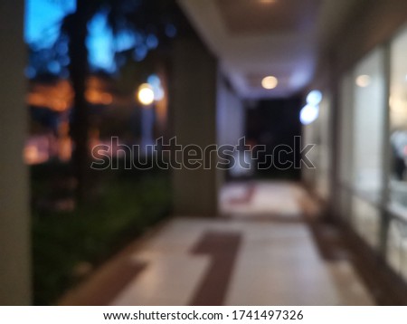 Abstract blur and defocused Condo corridor interior for background.Abstract blur corridor in building with bokeh for background usage.long hallway with doors and warm light