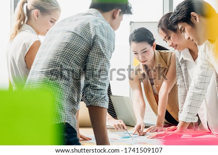 Group of asian young modern people in smart casual wear having a brainstorm meeting in smart office background. Business meeting, Planning, Strategy, Brainstorm, Development, Startup concept.