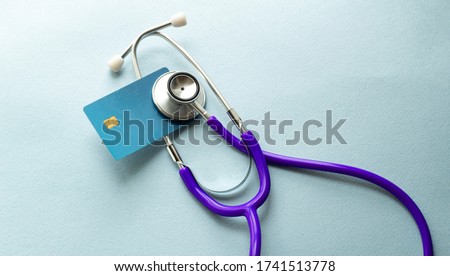 Stethoscope on a credit card concept with a brown background Royalty-Free Stock Photo #1741513778