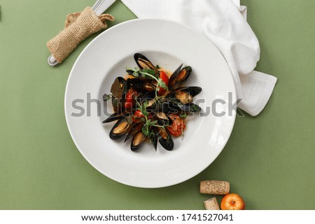 Boiled mussels and white wine on white stone table. Top view.